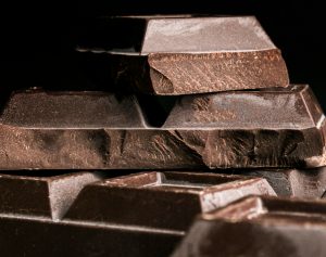 The image shows layers of dark compound chocolate