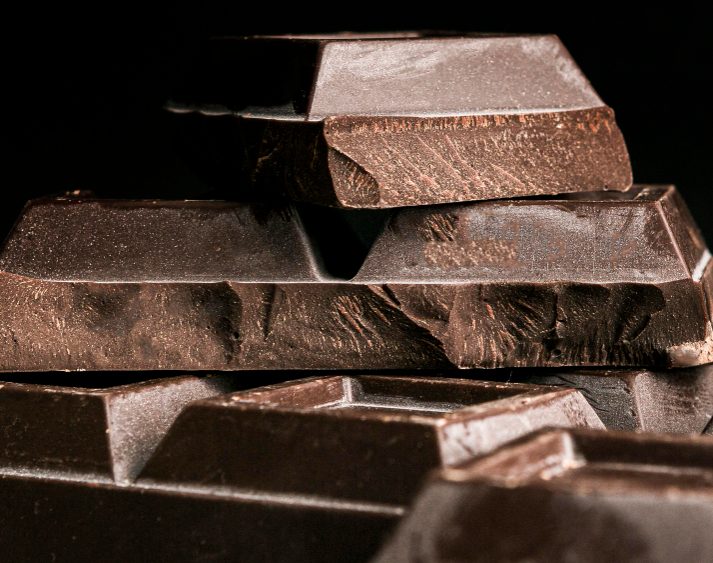 The image shows layers of dark compound chocolate