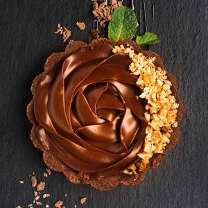 The image features a delicious chocolate cupcake adorned with colorful sprinkles. It highlights the delightful combination of chocolate spread and festive toppings.