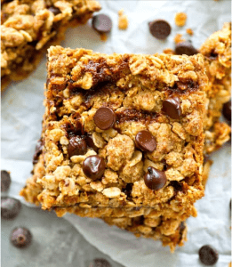 The image is a close-up of a cookie, highlighting its rice crispy texture and chocolate chips.