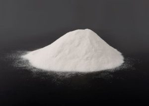 The image showcases a white powdery substance that is ice cream stabilizer, spread across a black surface.