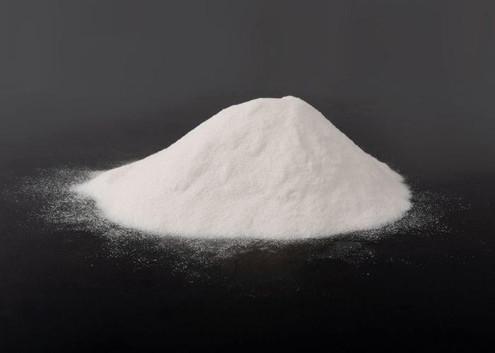 The image showcases a white powdery substance that is ice cream stabilizer, spread across a black surface.